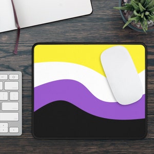 May include: A mouse mat with a yellow, white, purple and black design. The design is a wavy pattern that resembles the non-binary pride flag.