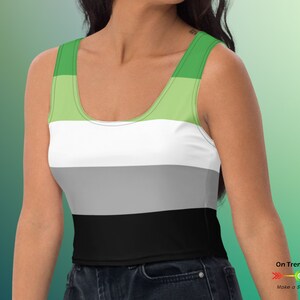 May include: A green, white, gray, and black striped crop top tank top. The tank top is a sleeveless, fitted style.