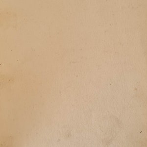 May include: A close-up of a blank, cream-colored page with handwritten text in black ink. The text reads "O. Tonge. 3-3-23."