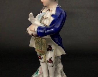 Vintage Saxony porcelain figurine of a man with a dove. 6&quot; court boy porcelain figure.