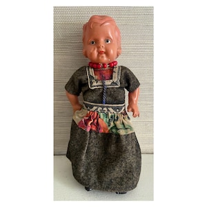 Vintage plastic doll in traditional folk costume. Dutch tourist souvenir doll.