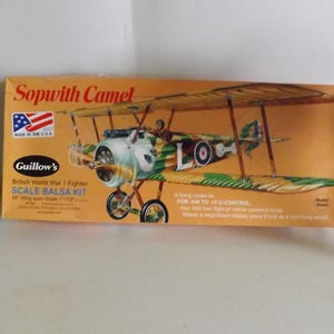 May include: A Guillow's Sopwith Camel scale balsa wood model kit for building a World War 1 fighter plane. The box shows a green, brown, and white model with a red, white, and blue roundel. The kit is for .049 to .15 U-control.