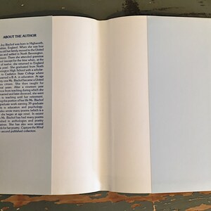 May include: A white book with a blue spine and the text "About the Author" on the front cover. The text describes the author's life and career, including her education, teaching experience, and writing.