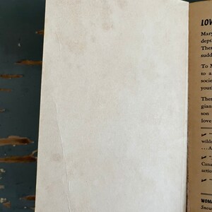 May include: A close-up of a book's inside cover with the text "LOV" and "Mary" at the top of the page. The text continues with "dept", "Ther", "sudd", "To M", "to a", "socie", "yout", "Ther", "gian", "son", "love", "wilde", "...A", "Cana", "actio", "WOM", "Snow".