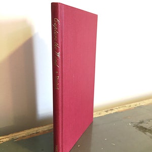 May include: A red hardcover book with the title "Capture the Wind" and the author "P. Bischof" written in gold lettering on the spine. The book is published by Harlo.