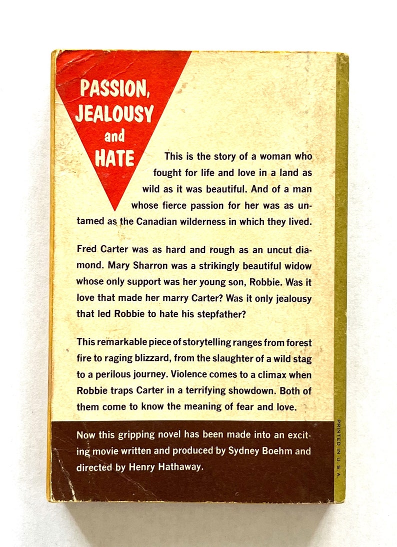May include: A book cover with a red triangle featuring the words "Passion, Jealousy and Hate". The book is about a woman who fights for life and love in a wild land. The book is a remarkable piece of storytelling that ranges from forest fire to raging blizzard.