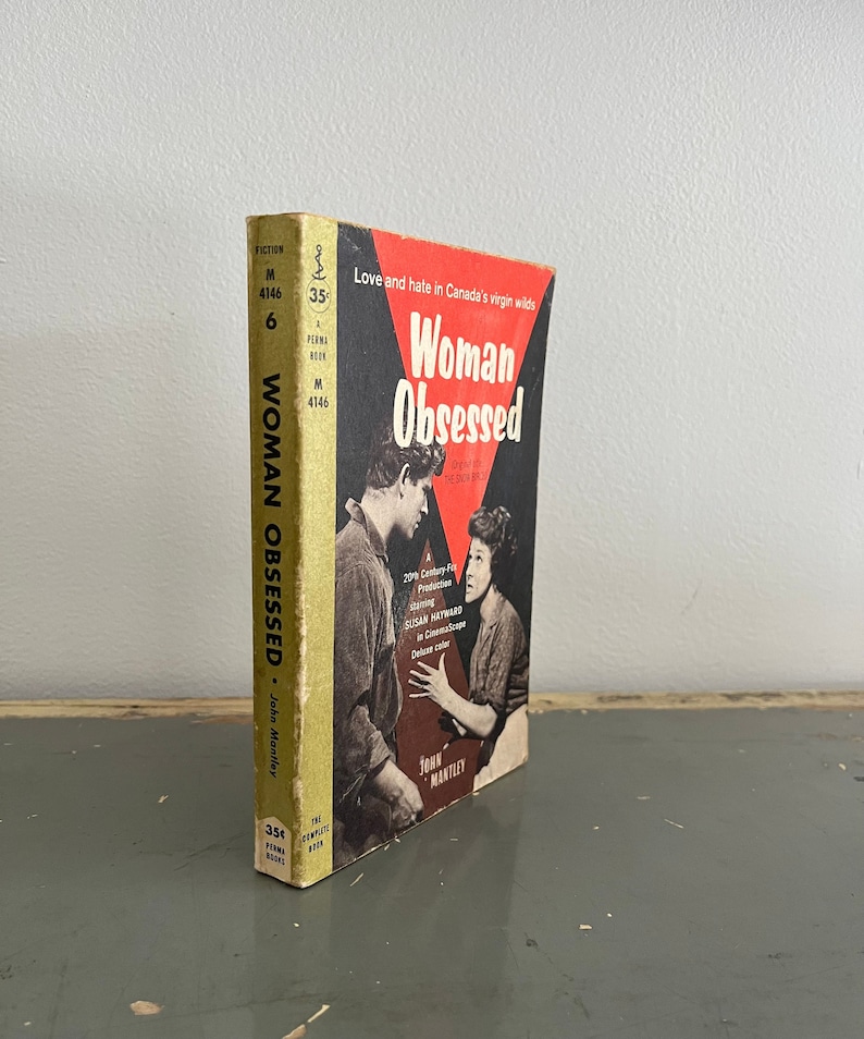 May include: A vintage paperback book titled "Woman Obsessed" with a red and white cover featuring a photo of two people. The book is part of a series called "The Complete Film Books" and is priced at 35 cents.