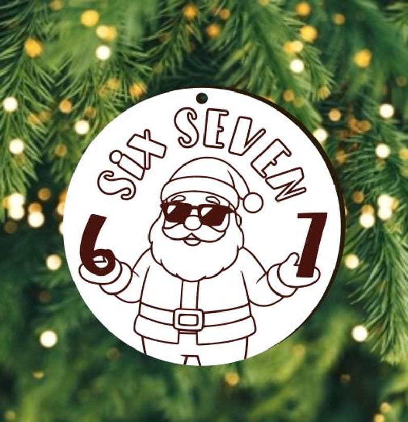 May include: A circular white Christmas decoration featuring a cartoon Santa Claus wearing sunglasses. The ornament has the words "SIX SEVEN" and the numbers 6 and 7. The background is a blurred image of a Christmas tree.