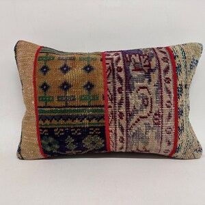 May include: A rectangular pillow with a patchwork design. The pillow is made of a beige fabric with a variety of colorful patterns, including red, blue, green, and yellow. The pillow is perfect for adding a touch of bohemian style to any room.