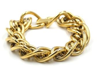May include: A gold-toned chain link bracelet with a twisted design. The bracelet has a clasp closure.