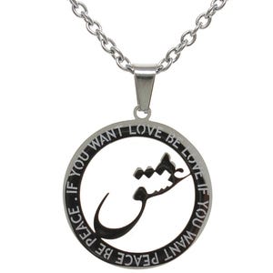 May include: A silver-colored pendant necklace with a circular charm. The charm features the text "IF YOU WANT LOVE BE LOVE IF YOU WANT PEACE BE PEACE" around the edge. A stylized Arabic script is in the center.