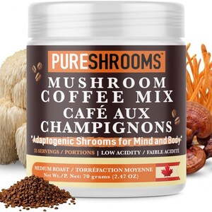 May include: A white jar of PureShrooms Mushroom Coffee Mix with the text "Caf&eacute; aux Champignons". The jar is surrounded by various mushrooms and a pile of coffee grounds. The label indicates 70 grams (2.47 oz) of product.