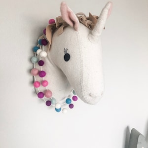 Spaced Unicorn Garlanding wool felt balls.
