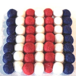 Red and white felt wool ball Trivet, with variations.