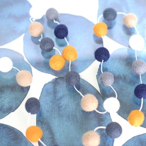 Navy, denim, white, taupe, gray, and bright gold wool felt ball Garland in modern color combo.