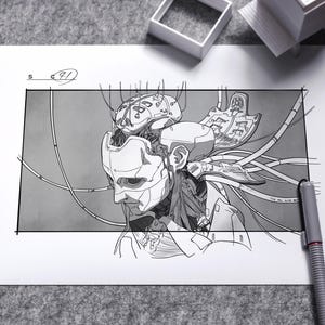 May include: A detailed monochrome drawing of a cyborg head, revealing internal mechanical parts and wiring. The artwork is on white paper, accompanied by a pen and miniature architectural models. The drawing is signed with the number 91.