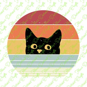 May include: A black cat with yellow eyes peeks out from behind a retro-style sunset graphic. The graphic has a red, orange, yellow, and blue color scheme with a vintage, distressed look.