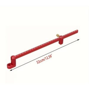 May include: A red metal woodworking tool with a ruler and a brass screw. The tool is 32cm long and has measurement markings. It has a base with a hole for mounting.