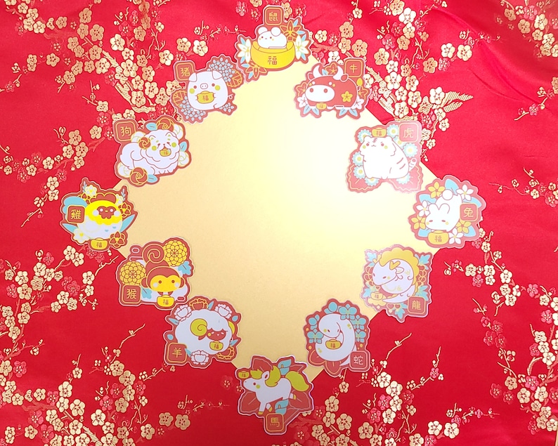 May include: Twelve colorful stickers featuring the Chinese zodiac animals. Each sticker has a cartoon animal with a Chinese character and the English translation of the animal's name. The stickers are on a red background with gold floral patterns.