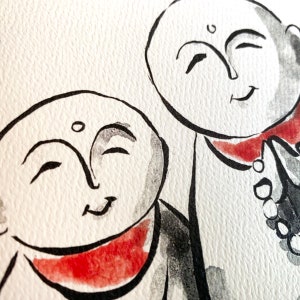 May include: Two black and white ink drawings of smiling faces with red accents. The faces are drawn in a simple style and have a peaceful expression.