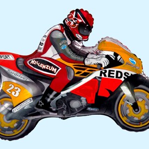 May include: A red, yellow, and black foil balloon shaped like a motorcycle with a rider wearing a red helmet. The motorcycle has the word "REDS" on the side and the number "23" on the back.