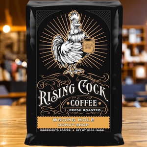 May include: A black bag of Rising Cock coffee with a rooster illustration holding a cup of coffee. The bag says "Fresh Roasted" and "Wrong Hole Donut Shop" with a net weight of 12 oz (340g).