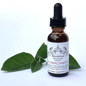 May include: A brown glass dropper bottle with a black cap containing Ashwagandha extract. The white label features the text Reverence Botanicals Extract of ASHWAGANDHA, Made with: Fresh leaves and roots of Withania somnifera, 1 fl oz.