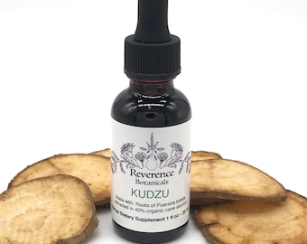 May include: A small brown glass bottle with a black dropper top. The bottle is labelled "Reverence Botanicals Kudzu" and contains a liquid extract made with roots of Pueraria lobata. The label also states that the extract is made with 40% organic cane alcohol and is a herbal dietary supplement. The bottle is sitting on a white surface with several slices of dried root.