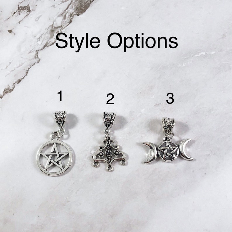 May include: Three silver charm options for jewelry making. Option 1 is a pentacle, option 2 is a tree of life, and option 3 is a triple moon with a pentacle in the center.