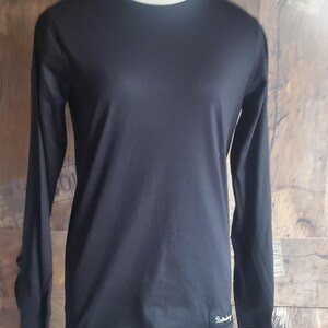 May include: Black long-sleeved shirt with a small black label on the bottom right side that says "Backcountry".