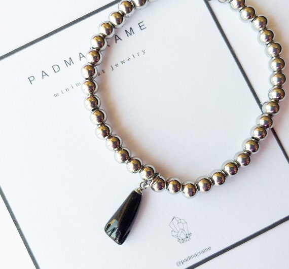 Pulsera protectora de acero y azabache