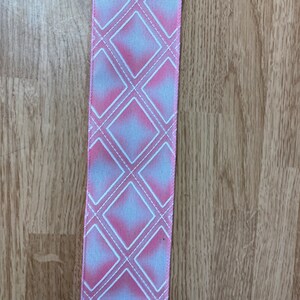 May include: Pink and white ribbon with a diamond pattern.