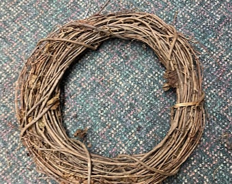 May include: A brown twig wreath, perfect for decorating a door or wall.