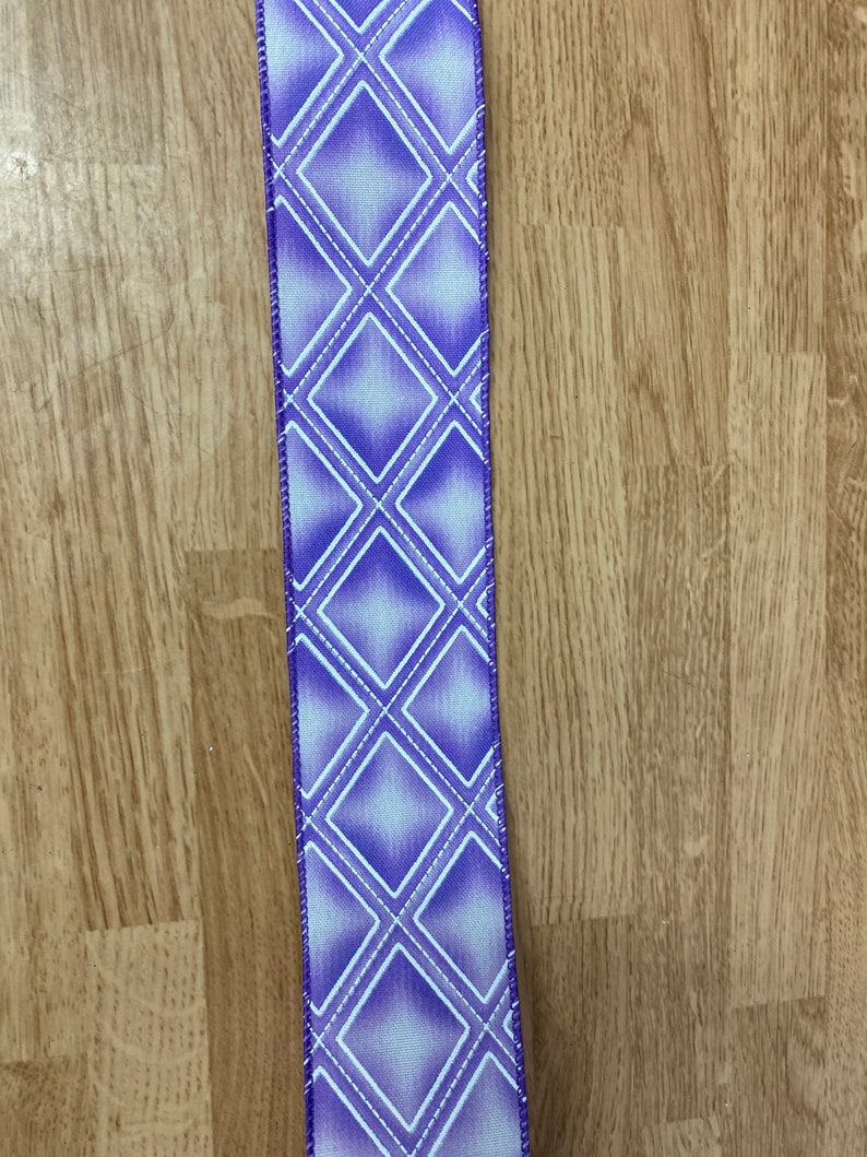May include: Purple ribbon with a white diamond pattern. The ribbon has a satin finish.
