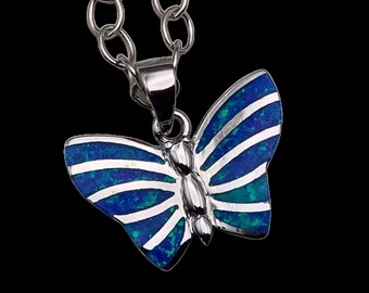 May include: A silver chain necklace with a blue and silver butterfly pendant.