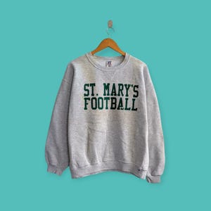 Sudadera vintage desgastada de fútbol de St. Mary&#39;s, jersey de cuello redondo de la Universidad de St. Mary&#39;s, ropa de calle, color gris, talla grande