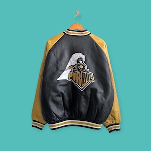 May include: Black and gold varsity jacket with the Purdue University logo on the back. The jacket has a black body, gold sleeves and trim. The Purdue logo is a white train with the word "PURDUE" in gold.