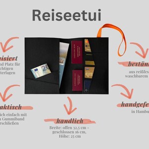 May include: Black travel document holder with orange handle, featuring multiple pockets for cards, documents, and currency. The holder is made of durable, washable paper and includes the text "Reiseetui". Open width is 12.8 inches, closed is 6.3 inches, and height is 9.8 inches.