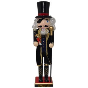 May include: A nutcracker figure wearing a black top hat with a red band, a black coat with gold trim, and a blue vest. The figure has white hair, a black eye patch, and a mustache. It holds a small nutcracker and a gold-topped staff, standing on a base labeled INVENTOR.