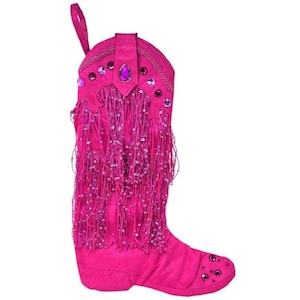 May include: A vibrant pink Christmas stocking shaped like a cowboy boot. The boot is adorned with sparkling sequins, fringe, and decorative jewels. A loop is attached at the top for hanging. The boot is a festive holiday decoration.