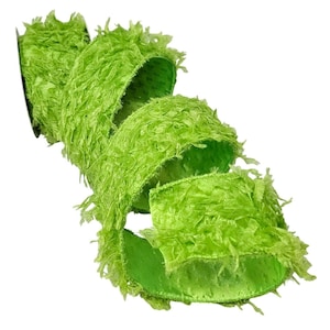 May include: A roll of bright green ribbon with a textured, fringed surface. The ribbon is curled and layered, revealing a smooth, satin-like underside. The ribbon is a vibrant, eye-catching shade of green.