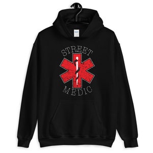 May include: Black hooded sweatshirt with a red star of life graphic and the text "STREET MEDIC" in white.