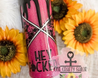 May include: Pink glitter tumbler with black dripping paint and the text "Hey F*ckers" in black. The tumbler is surrounded by sunflowers and a watermark for "One Crafty Sailor".