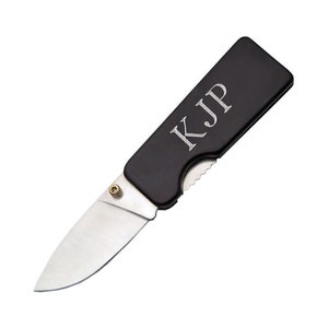 May include: A black pocket knife with a silver blade and the initials "KJP" engraved on the handle.
