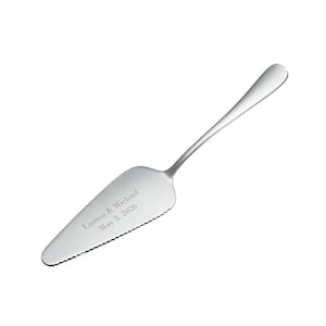 May include: A silver cake server with a serrated edge and a personalized inscription that reads "Lauren & Michael May 3, 2026".