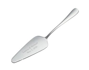 May include: A silver cake server with a serrated edge and a personalized inscription that reads "Lauren & Michael May 3, 2026".