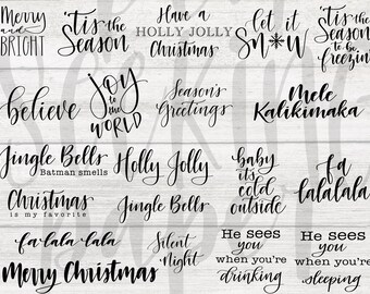 May include: A collection of 16 Christmas-themed phrases and sayings in black script font on a white wood background. The phrases include "Merry and Bright", "Tis the Season", "Have a Holly Jolly Christmas", "Let it Snow", "Tis the Season to be Freezin", "Believe", "Joy to the World", "Season's Greetings", "Mele Kalikimaka", "Jingle Bells Batman Smells", "Holly Jolly", "Baby it's Cold Outside", "Fa La La La La", "Silent Night", "He Sees You When You're Drinking", "He Sees You When You're Sleeping", "Christmas is My Favorite", "Jingle Bells", and "Fa La La La La".
