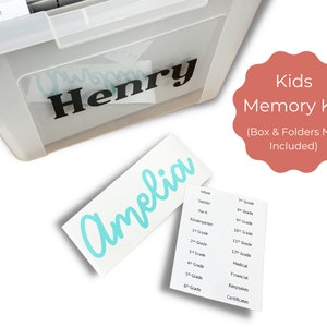 May include: A teal blue vinyl sticker with the name "Amelia" written in cursive. The sticker is on a white background. The image also shows a clear plastic storage box with the name "Henry" written on it in black vinyl. The box has folders labeled with different age groups and categories, such as "Infant", "Toddler", "Pre-K", "Kindergarten", "1st Grade", "2nd Grade", "3rd Grade", "4th Grade", "5th Grade", "6th Grade", "7th Grade", "8th Grade", "9th Grade", "10th Grade", "11th Grade", "12th Grade", "Medical", "Financial", "Keepsakes", and "Certificates". The image also includes a pink circle with the text "Kids Memory Kit (Box & Folders Not Included)".