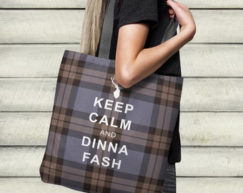 May include: A brown and gray tote bag with a plaid pattern. The bag has a white stag silhouette and the text "Keep Calm and Dinna Fash" printed on it.
