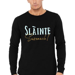 May include: Black long-sleeve t-shirt with the text "Sl&aacute;inte Sassenach!" in blue and gold lettering.
